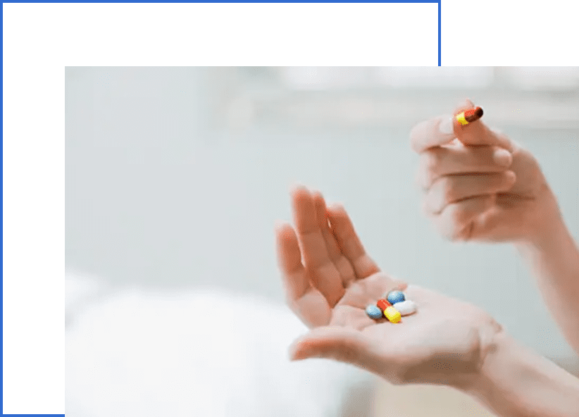 A person holding pills in their hands